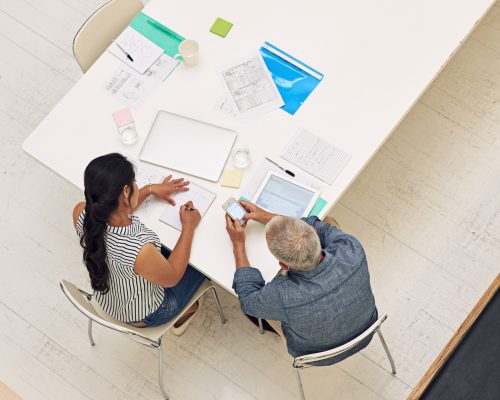 Shot of a two colleagues having a meeting in a modern office