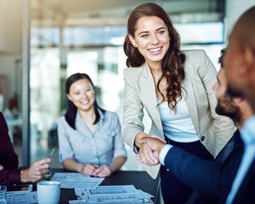 Cropped shot of two businesspeople shaking hands during a meeting in the boardroom